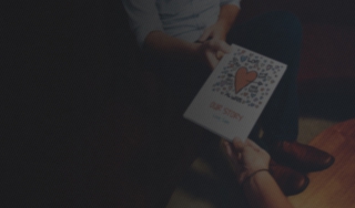 Woman gifting a LoveBook to its recipient